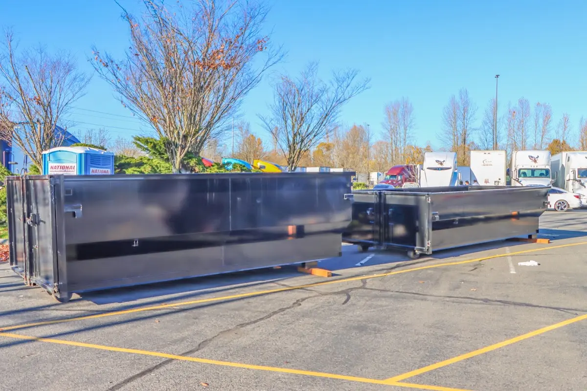 Professional dumpster rental service with roll-off container on residential driveway in Rushville